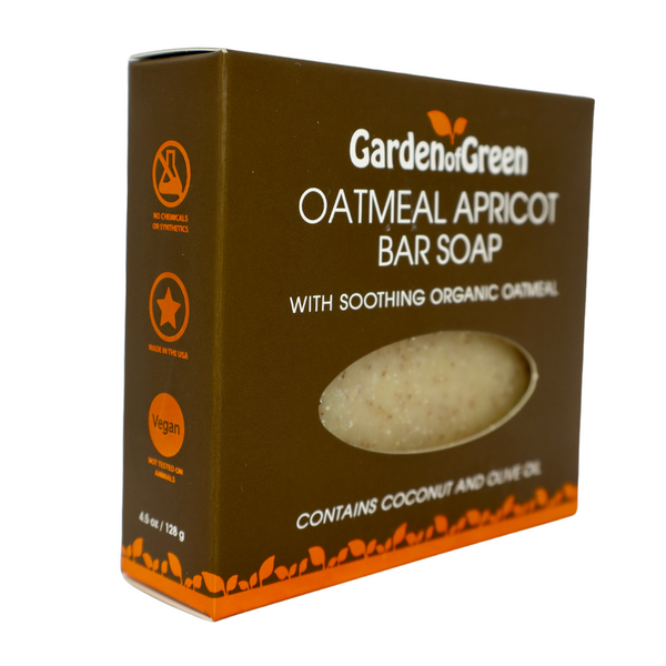 Garden of Green's oatmeal apricot bar soap side view in dark brown box with orange leaf foil on the bottom of box. the background it white