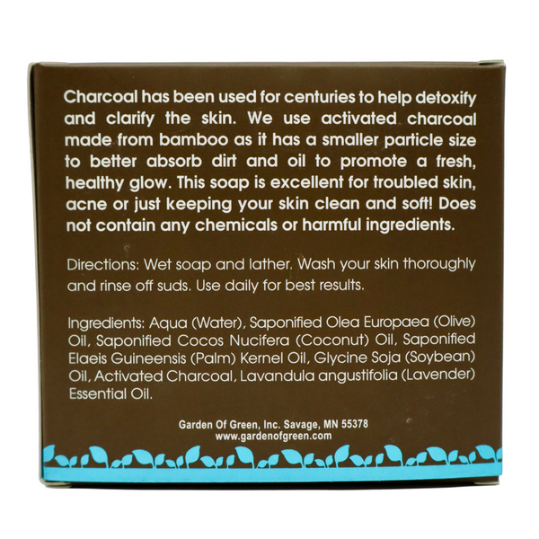 Garden of Green black charcoal bar soap back view in a dark brown box with a light blue foil with leaves on the bottom of the box. the background is white. 