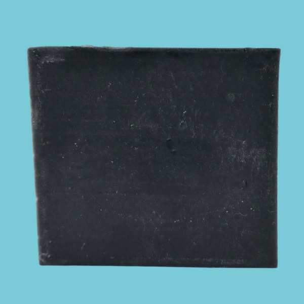 Charcoal soap standing up like a square with a light blue background