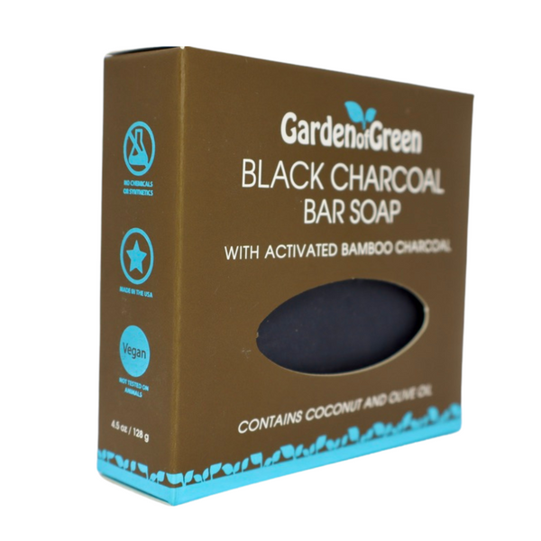 Garden of Green black charcoal bar soap side view in a dark brown box with a light blue foil with leaves on the bottom and sides of the box. the background is white