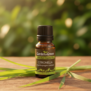 Citronella essential oil front view sitting on a wood table with a leaf on the table. 