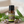 Clary Sage essential oil in amber glass bottle, family-crafted aromatherapy oil, front view sitting on a wood table kitchen 