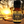 Relax 100% essential oil blend front view with a beautiful sunset behind the bottle of oil. there is a hammock and trees and water and sand