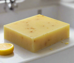 Lemon bar soap with bubbles by a kitchen sink someone washing their hands