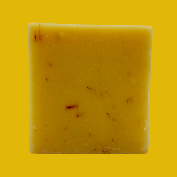 Italian Lemon Bar Soap plain standing up like a a square on a yellow background