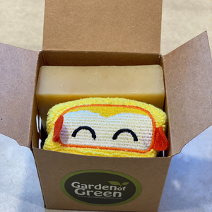 Bar of lemon soap and yellow washcloth with smiley face design in a 'Garden of Green' branded box. great for gifting