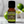 Lime essential oil in amber glass bottle, family-crafted aromatherapy oil, front view with limes in the background