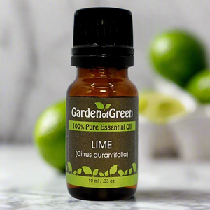 Lime essential oil in amber glass bottle, family-crafted aromatherapy oil, front view with limes in the background