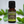Myrtle essential oil in amber glass bottle, family-crafted aromatherapy oil, front view on with green leaves in the background