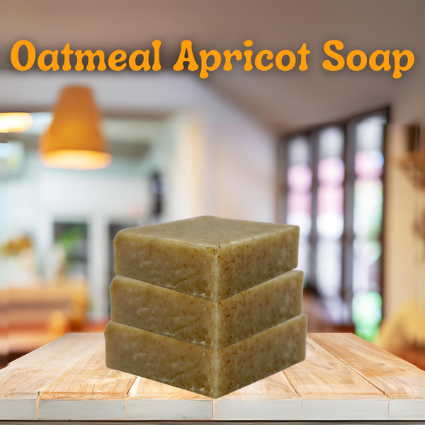 the title is "oatmeal apricot soap" is at the top of the page in all orange. 3 bars of soap are stacked on top each other sitting on a table in a kitchen in the background 