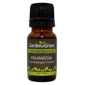 Palmarosa essential oil in amber glass bottle, family-crafted aromatherapy oil, front view on white background