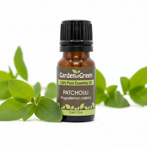 Patchouli essential oil front view with a white background, patchouli leaves next to it 