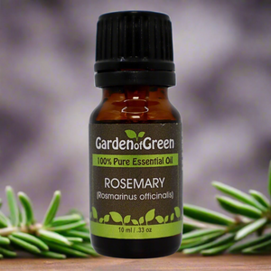 rosemary Garden of green essential oil front view sitting on a wood table with a leaf on the lower left hand side. green background with sun shining through the top left.