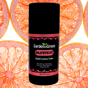 garden of green's grapefuit solid lotion tube front view with slices of grapefruit and white background