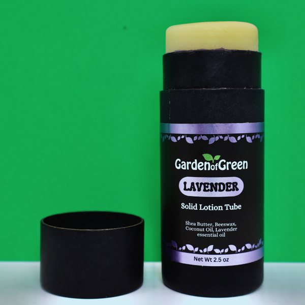 Garden of Green's Lavender solid lotion tube front view sitting on a white table with a green background