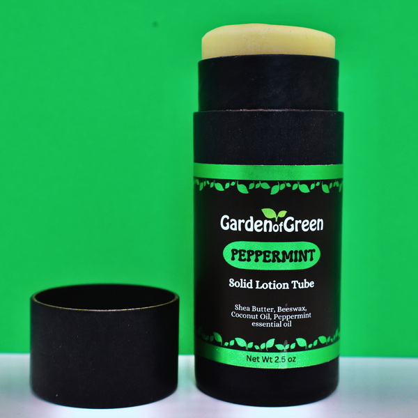 Garden of Green's peppermint solid lotion tube front view sitting on a white table with a green background