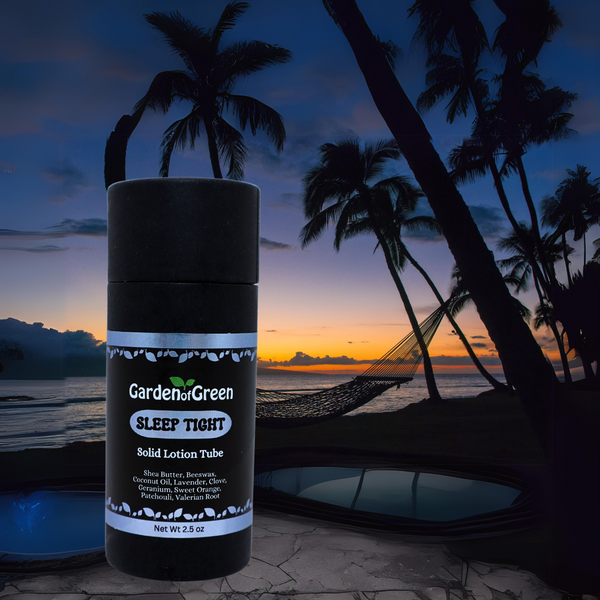 Garden of Green's Sleep Tight solid lotion tube front view sitting on a patio with a pool and the ocean. the sun is setting with palm trees on the top right side in the background