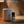 Sleep Tight essential oil roller blend crafted with lavender, sweet orange, patchouli, and valerian root, background bedroom nightstand with diffuser going at night