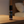 Garden of Green essential oil bottle on a wooden surface with a blurred background