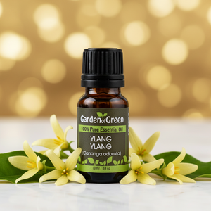 Ylang Ylang essential oil front view sitting with flowers in the background